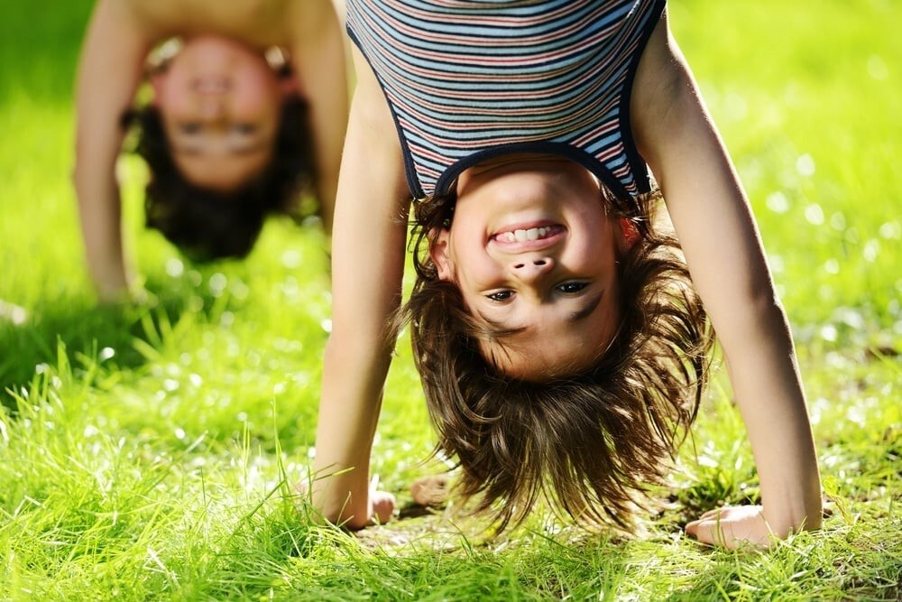 Portraits of happy kids playing upside