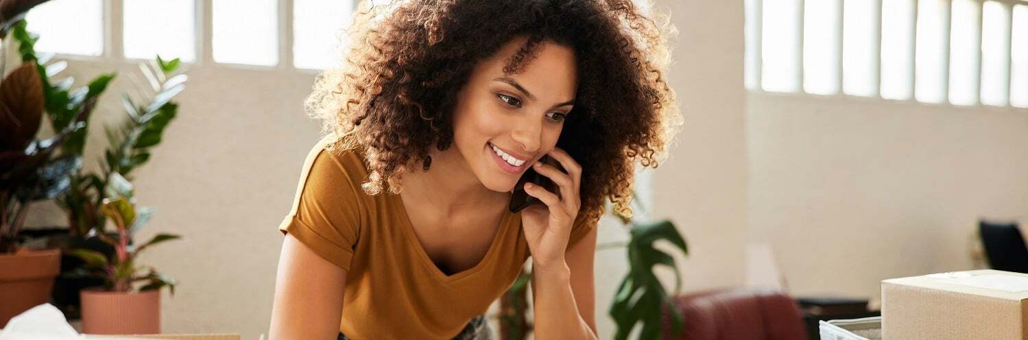 Woman on the phone looking at her laptop