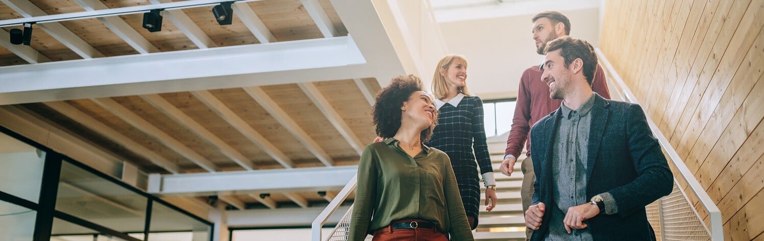 group-of-people-walking-down-steps-in-an-office