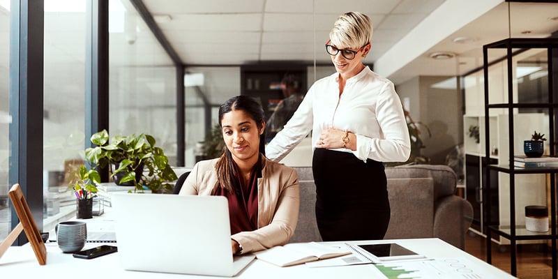 two-women-looking-at-a-laptop