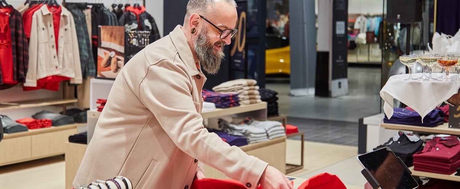 Retail store employee folding clothes