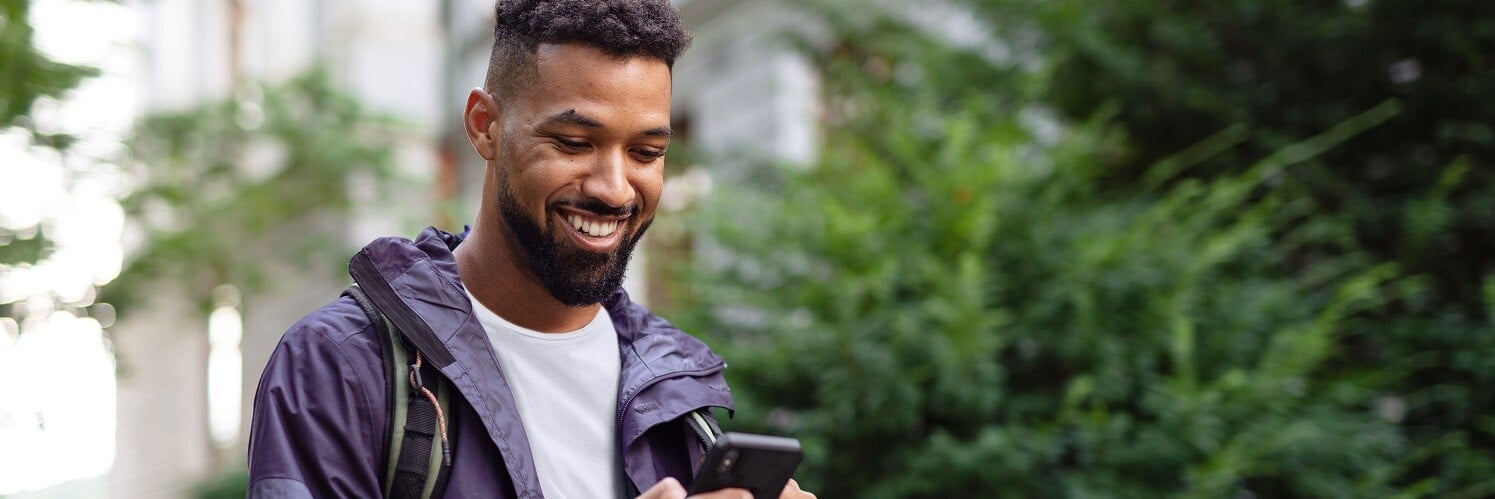 Man walking looking at phone