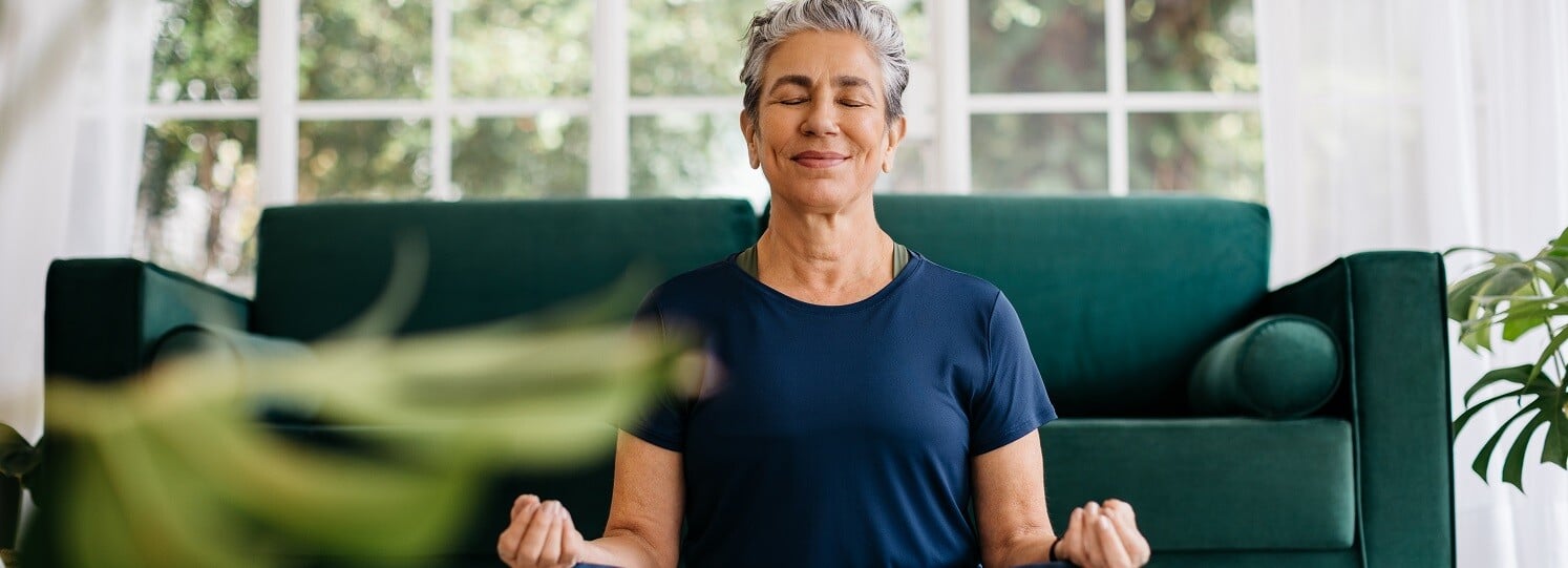 Woman sitting on the floor meditating