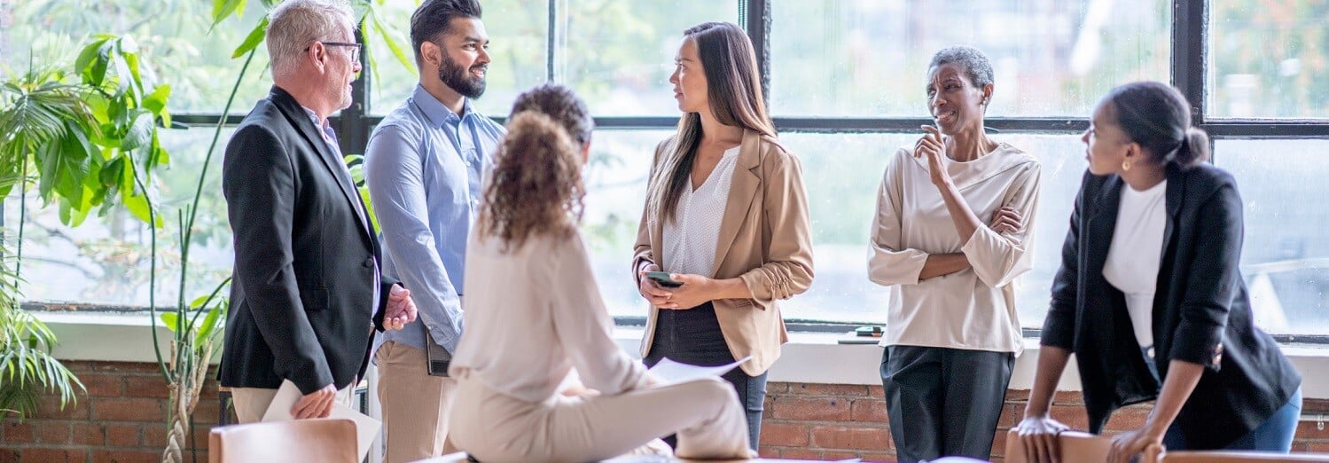 group-of-people-talking-around-boardroom-table