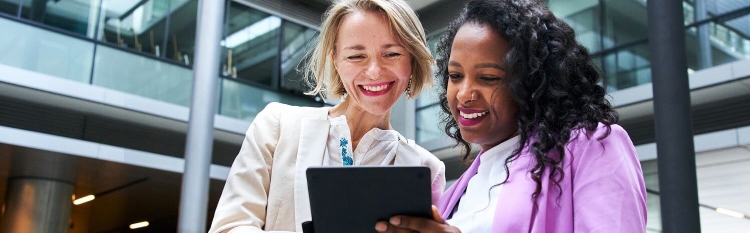 two-women-at-work-looking-at-tablet-1