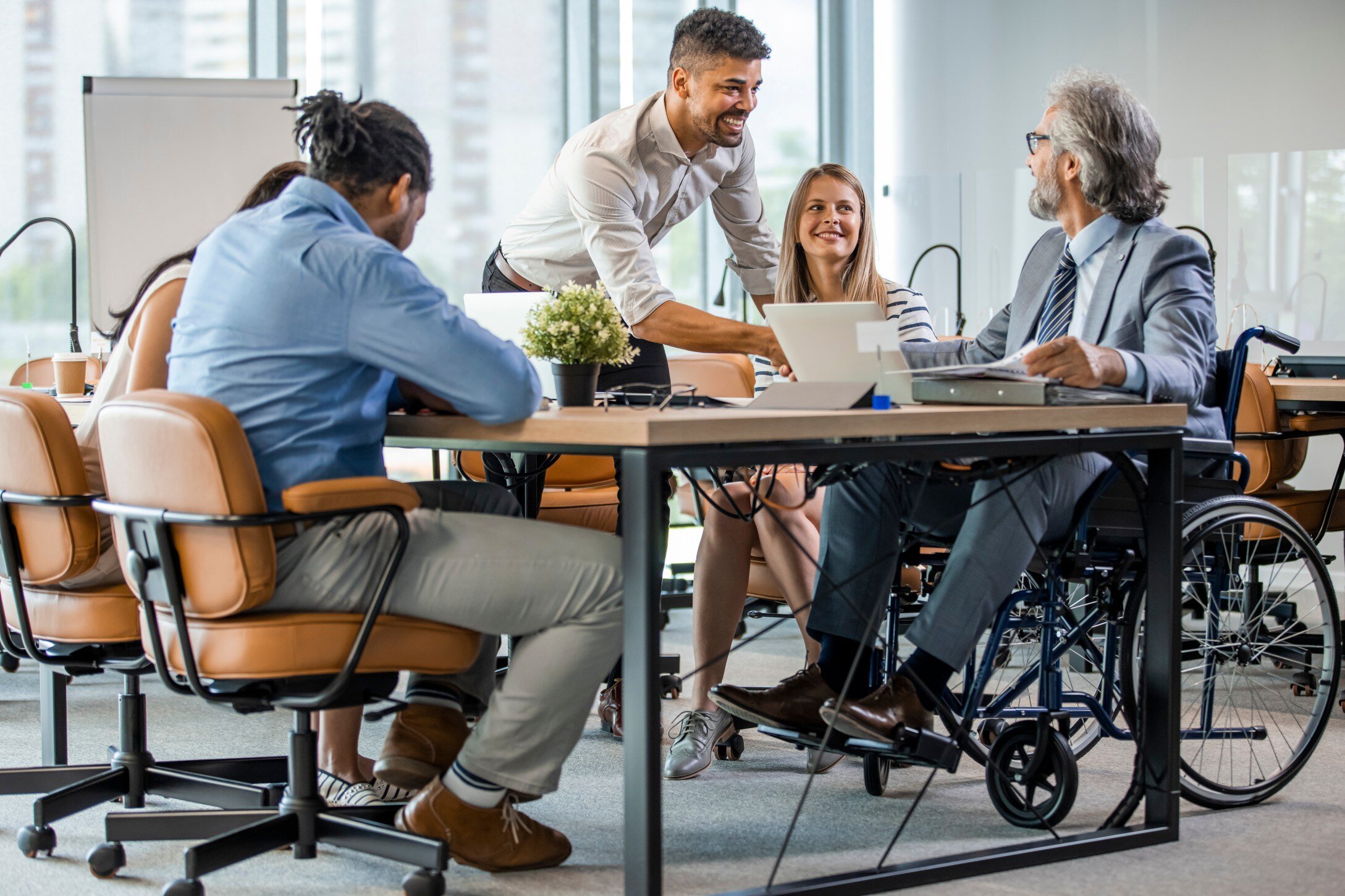 Employees seated around a table