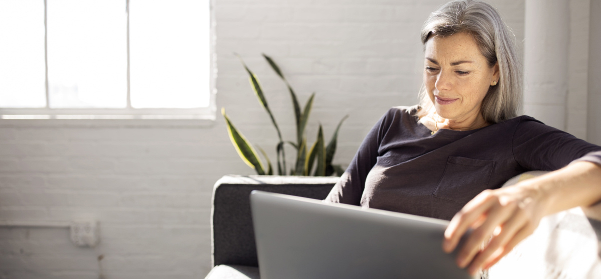 Woman sitting on couch with laptop