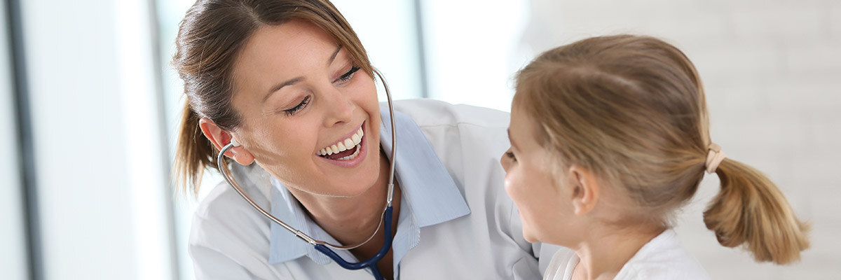 Smiling nurse practicioner during a consult with a child