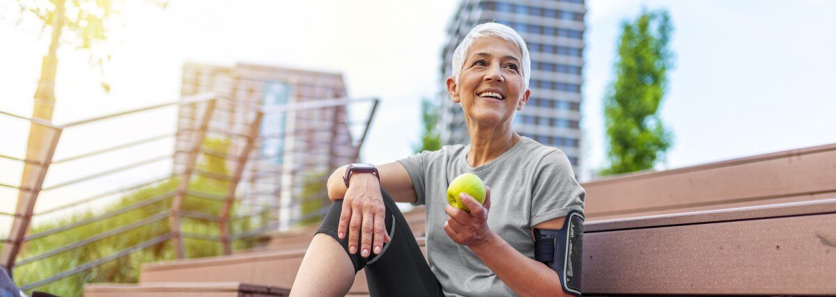 Happy woman mindfully eating after her workout