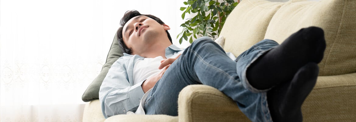 Man lying down on his sofa preventing his iron deficiency