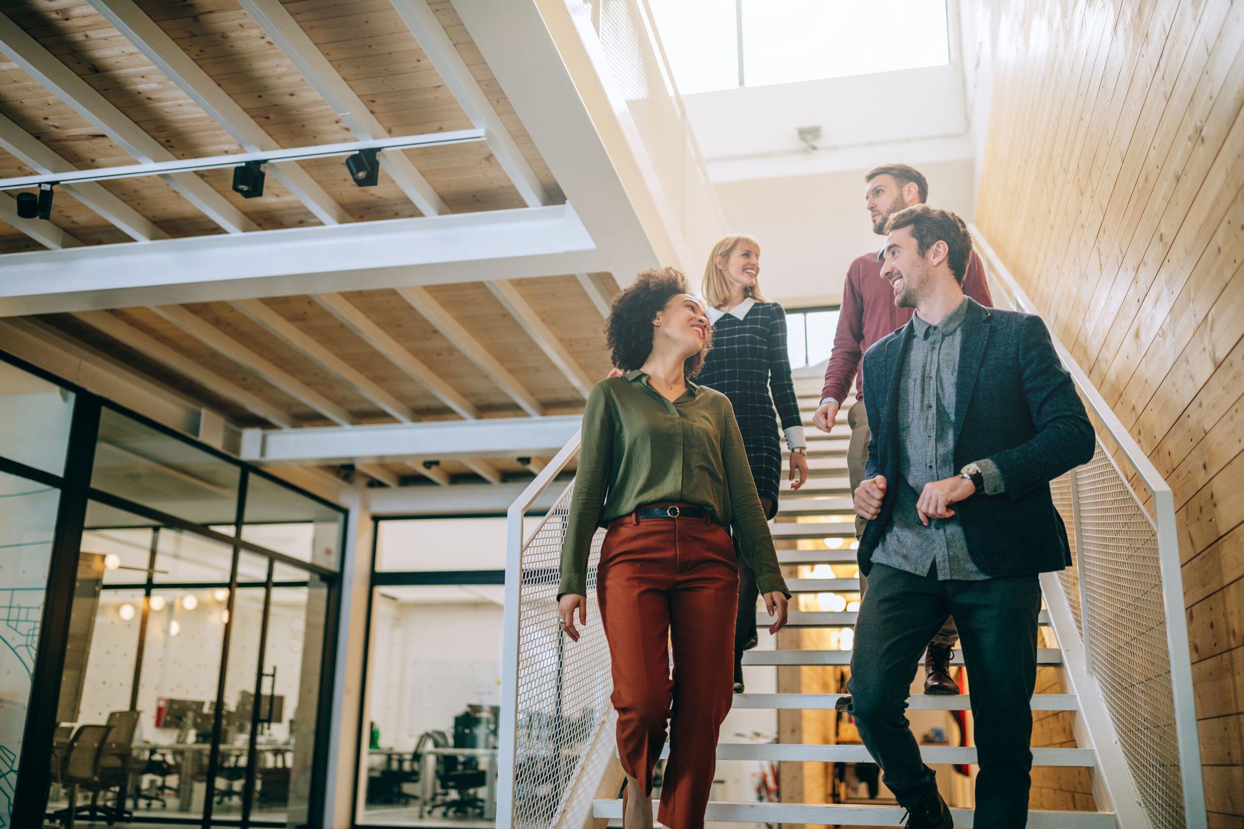 Group of employees walking down the steps in an office