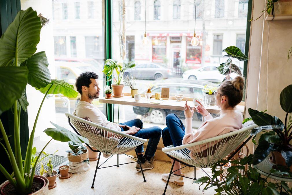 Man and woman in coffee shop discussing