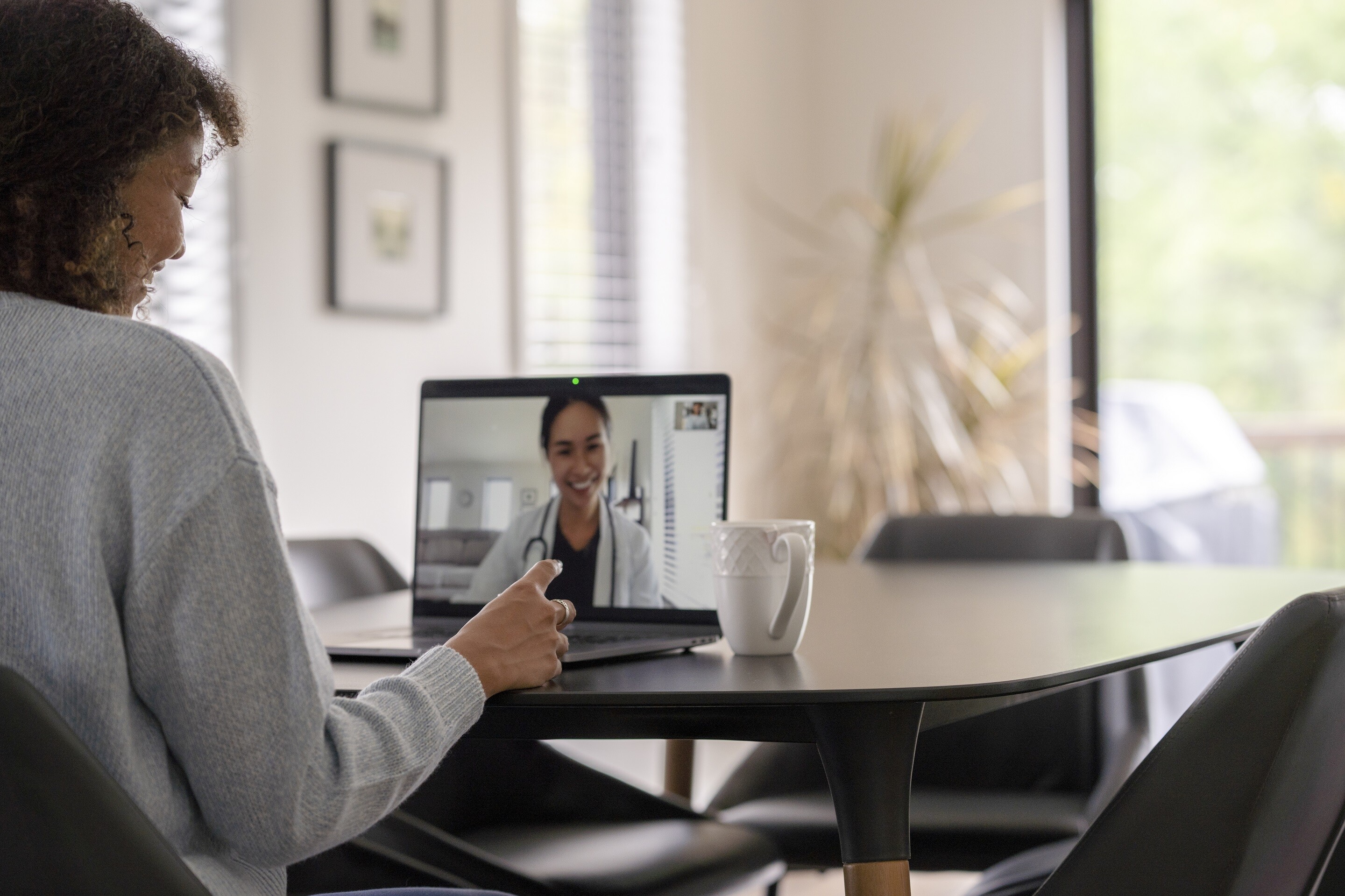 Woman in a virtual consultation with a female physician