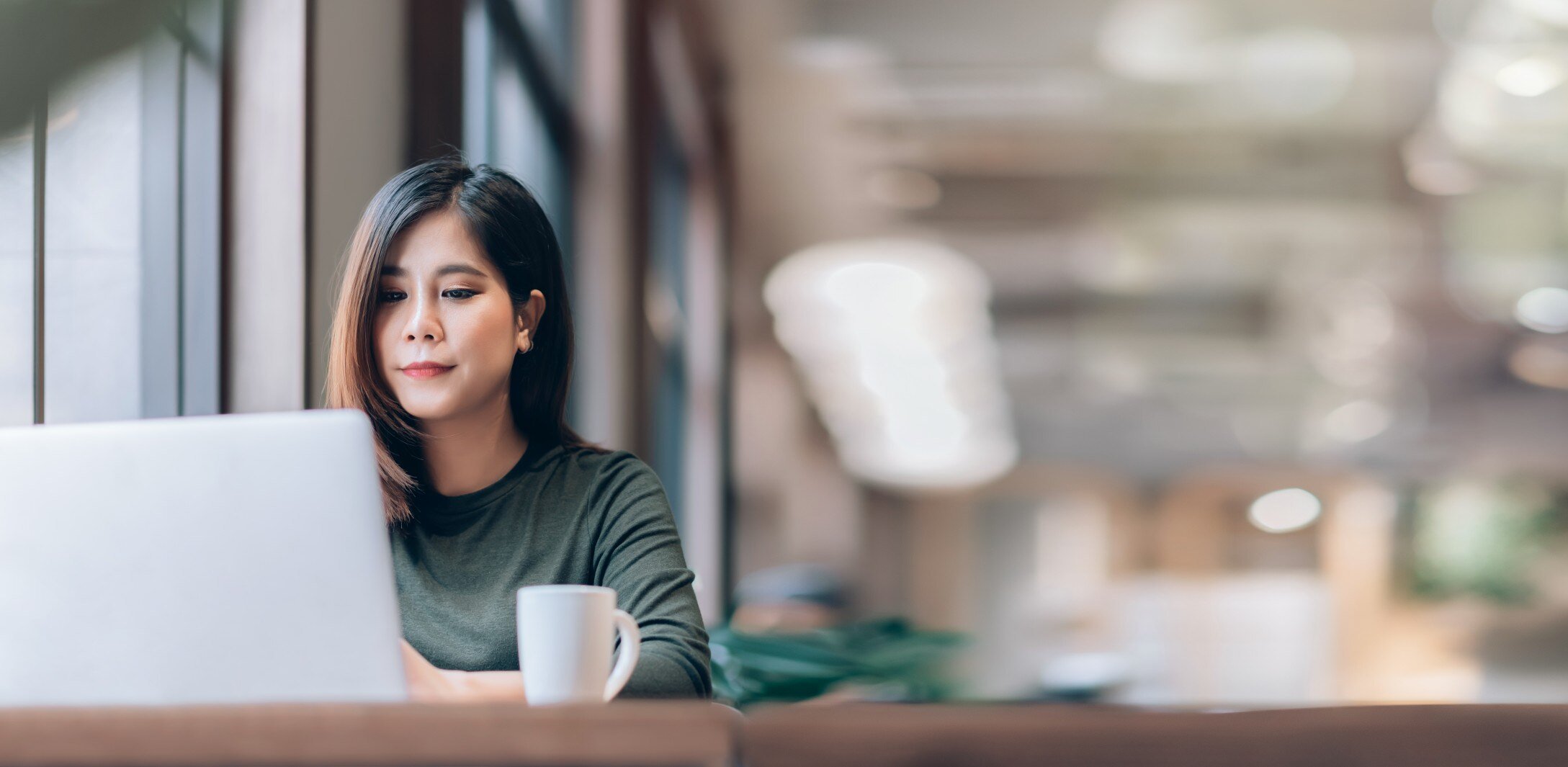 Woman sitting at desk with laptop