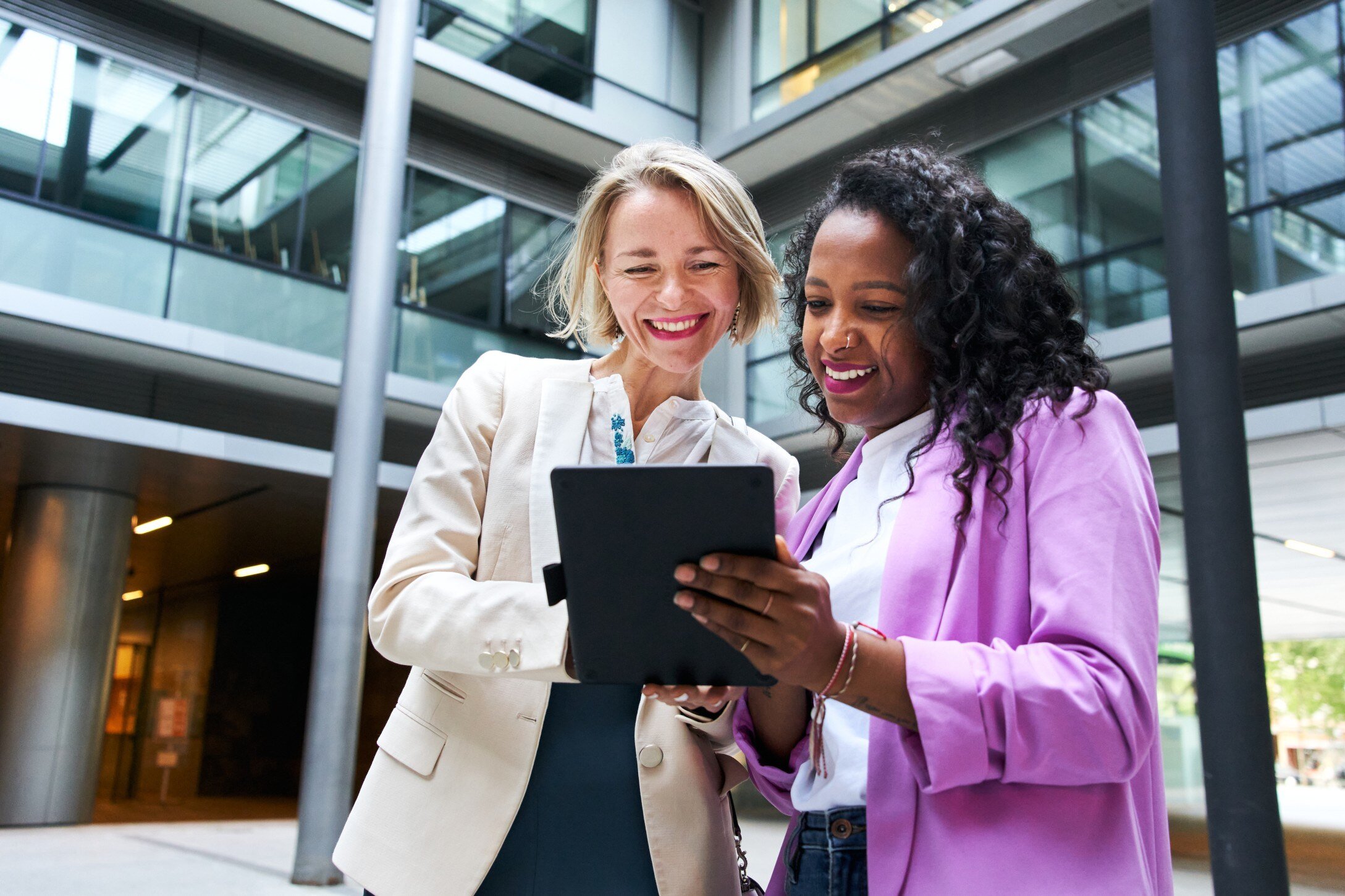 Two women at work looking at tablet