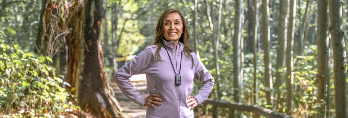 Woman in the forest with a TELUS Health medical alert pendant