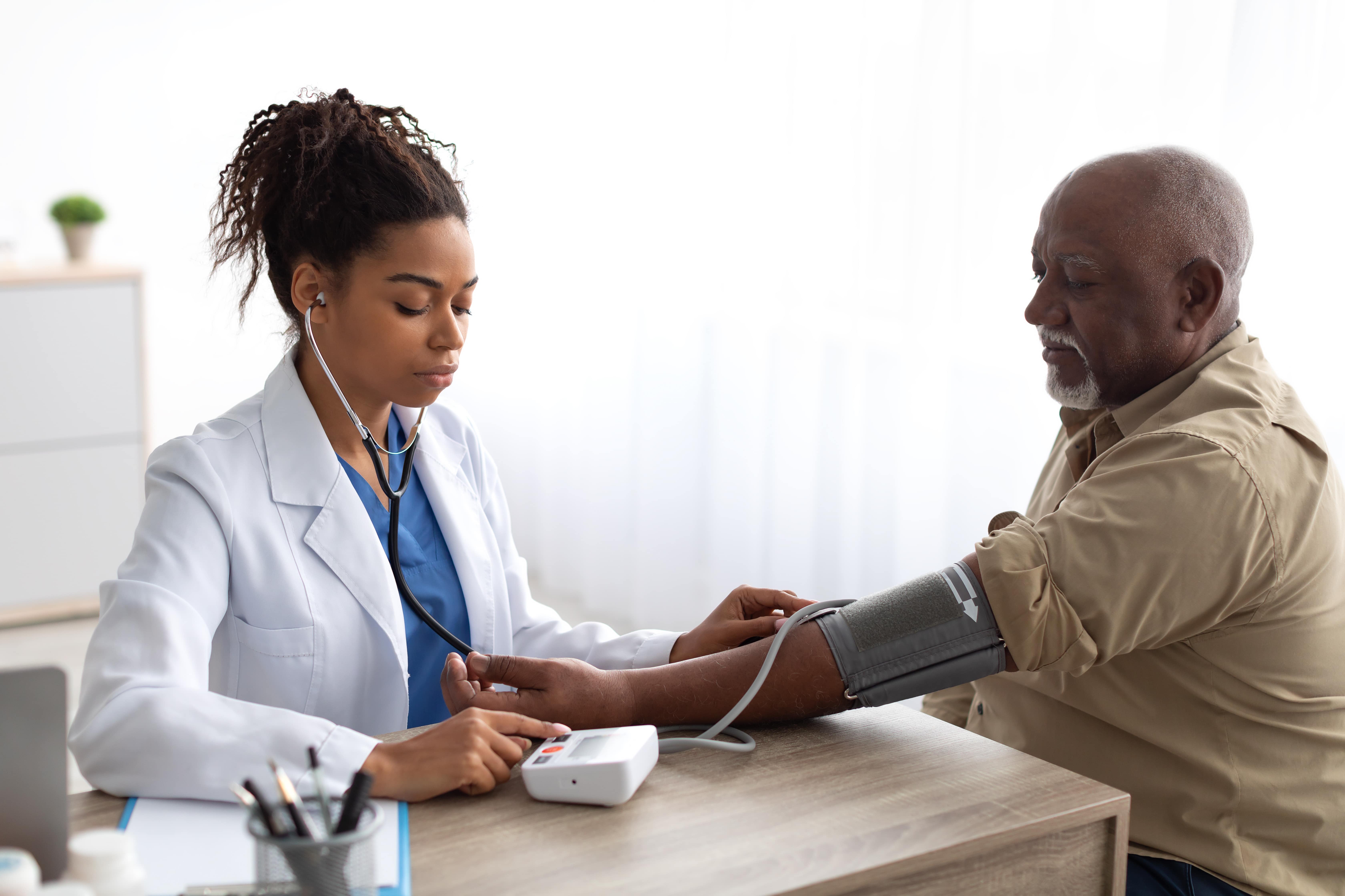 Doctor checking blood pressure