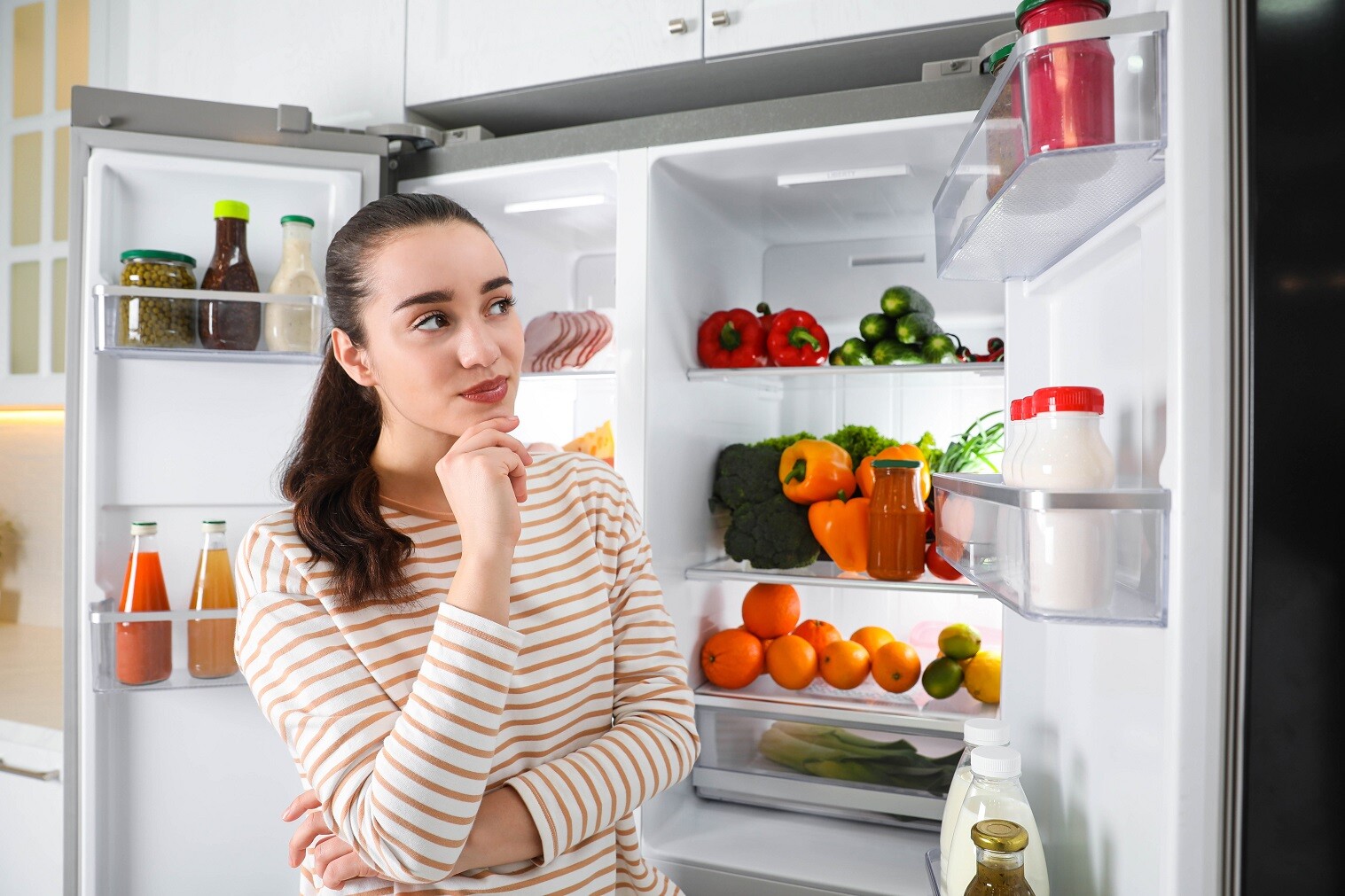 Woman standing by her fridge