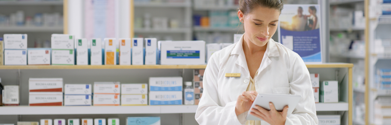 Pharmacist with tablet in hand