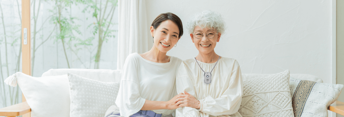 Maman et sa fille assise sur un canapé main dans la main