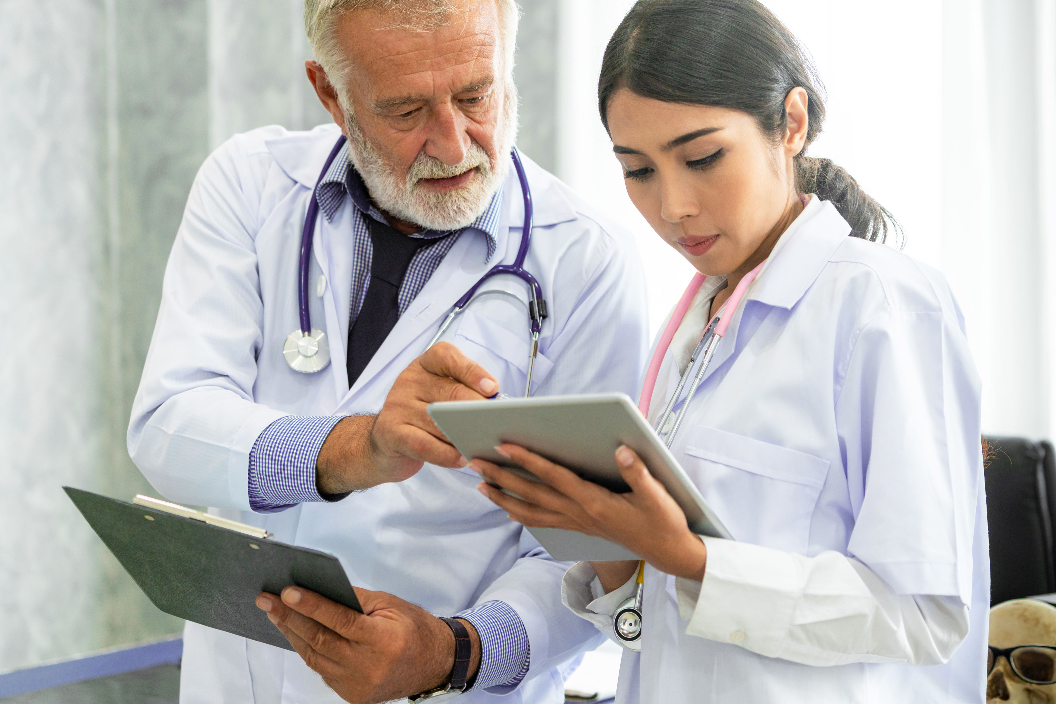 Doctors looking at a tablet